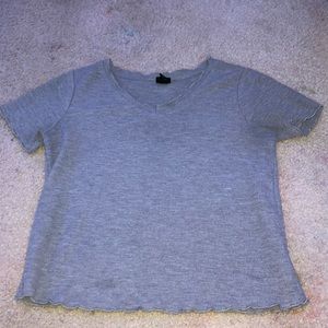 The shirt has been worn it is a gray T-shirt fringe on sleeves,bottom,neckline